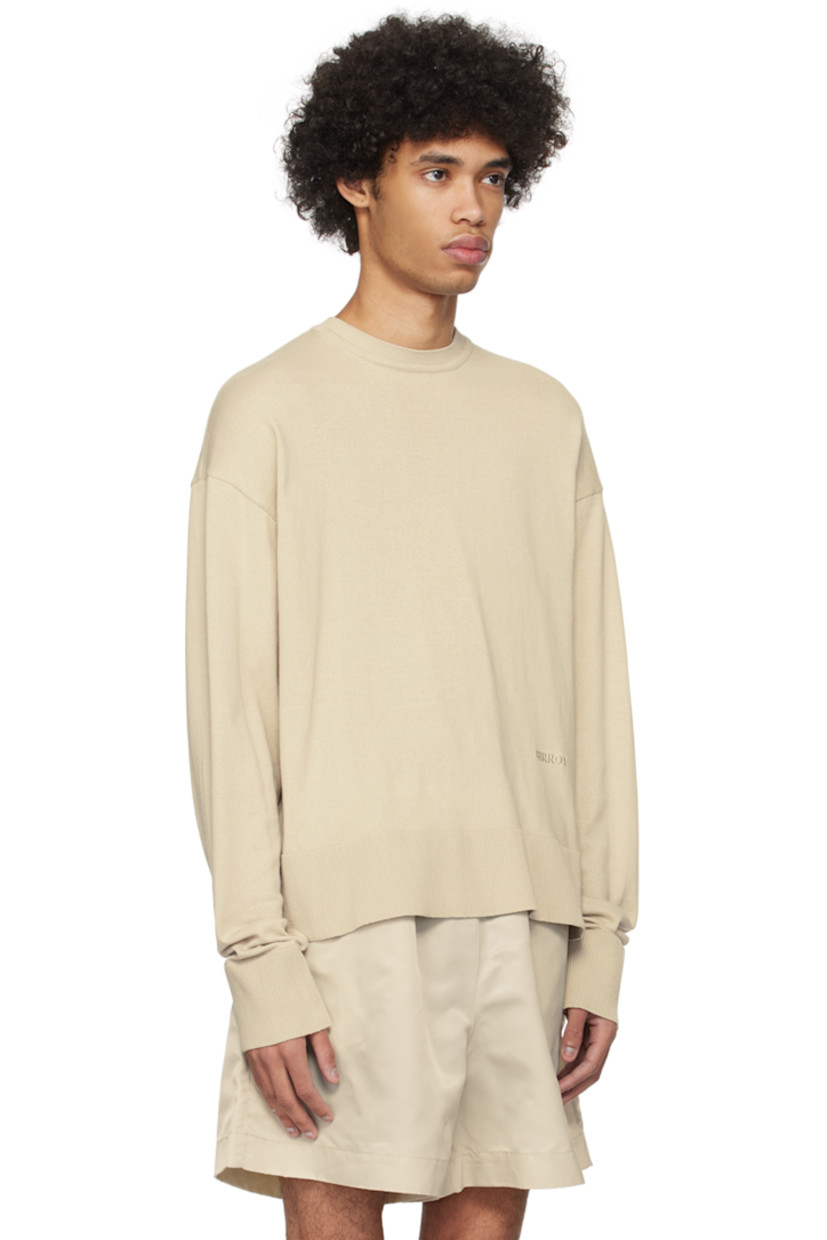 Knit BCI-certified cotton sweater.

· Rib knit crewneck, hem, and cuffs
· Logo embroidered front
· Dropped shoulders

Supplier color: Smoke bone