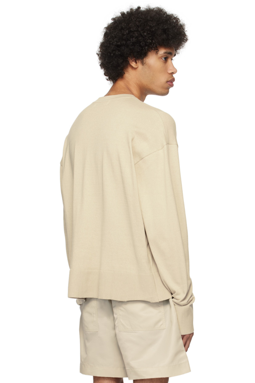 Knit BCI-certified cotton sweater.

· Rib knit crewneck, hem, and cuffs
· Logo embroidered front
· Dropped shoulders

Supplier color: Smoke bone