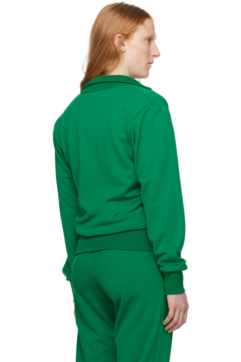 Polyester jersey track jacket. 

· Rib knit stand collar, hem, and cuffs
· Logo hardware at zip closure 
· Logo embroidered at chest 
· Zip pockets

Supplier color: Green