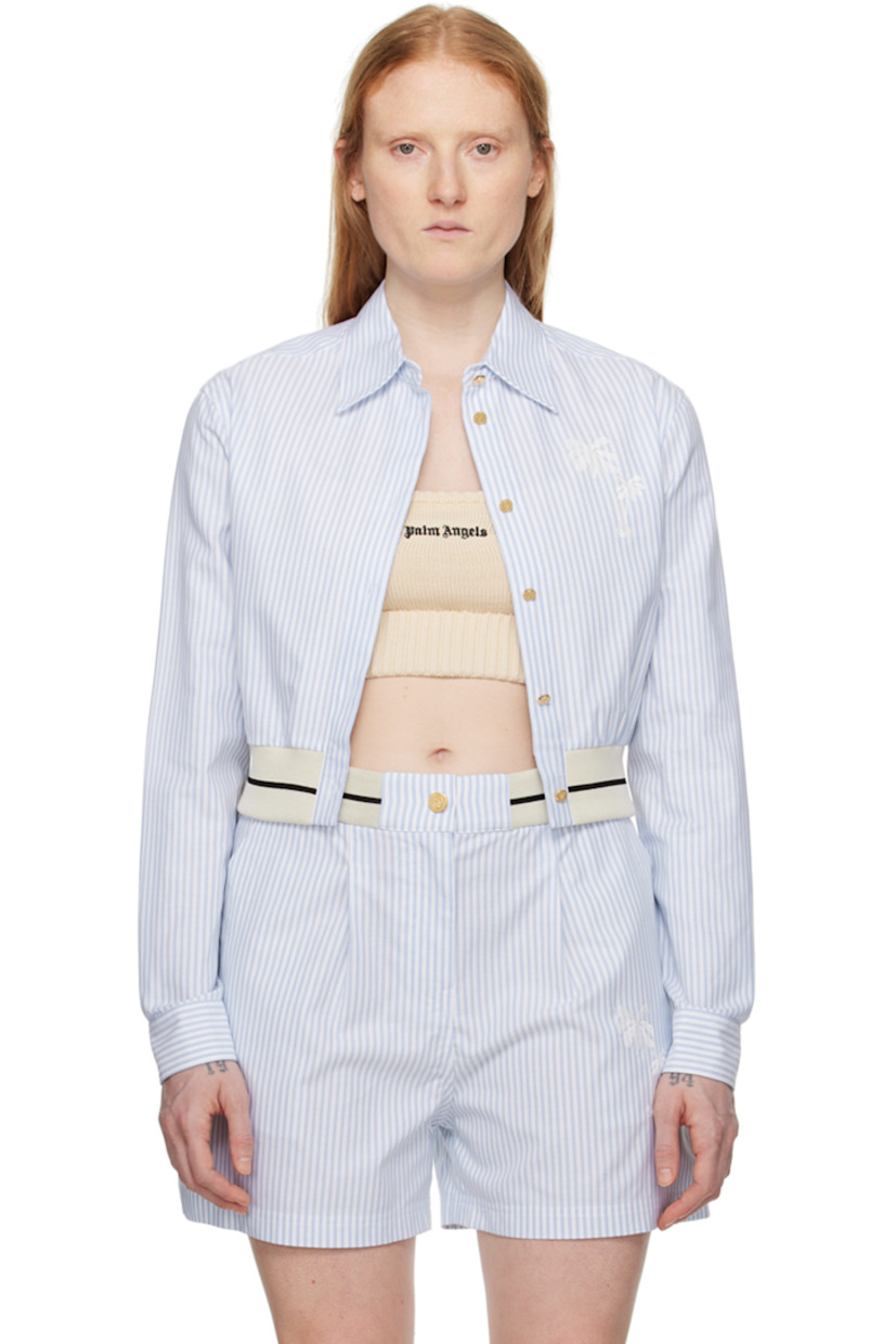 Cotton oxford cloth shirt. 

· Spread collar 
· Button closure 
· Graphic embroidered at chest
· Striped elasticized cropped hem
· Single-button barrel cuffs
· Locker loop at back yoke 
· Logo-engraved gold-tone hardware

Supplier color: Light blue