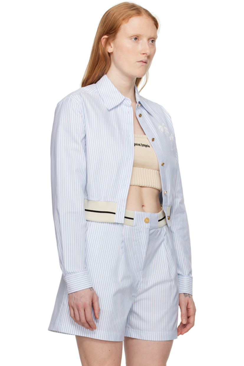 Cotton oxford cloth shirt. 

· Spread collar 
· Button closure 
· Graphic embroidered at chest
· Striped elasticized cropped hem
· Single-button barrel cuffs
· Locker loop at back yoke 
· Logo-engraved gold-tone hardware

Supplier color: Light blue