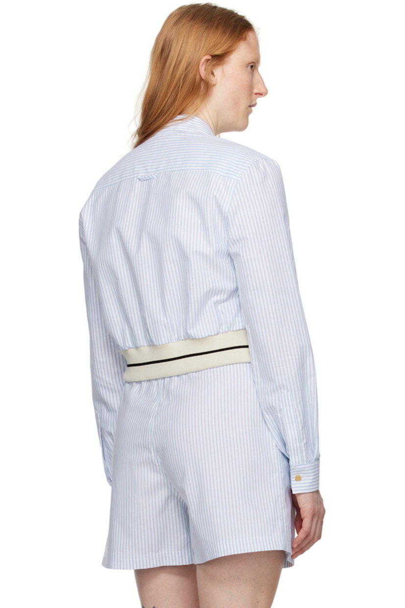 Cotton oxford cloth shirt. 

· Spread collar 
· Button closure 
· Graphic embroidered at chest
· Striped elasticized cropped hem
· Single-button barrel cuffs
· Locker loop at back yoke 
· Logo-engraved gold-tone hardware

Supplier color: Light blue