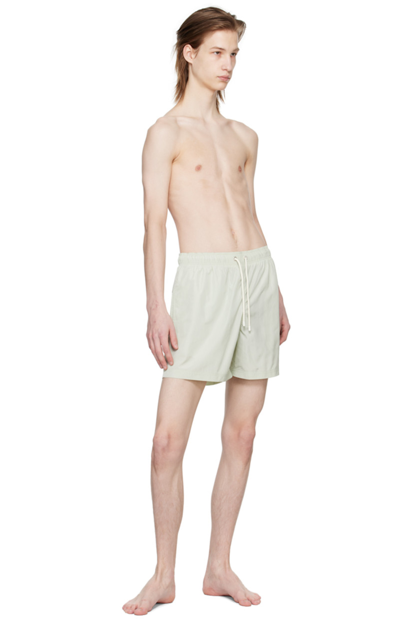Polyester taffeta swim shorts. 

· Drawstring at elastisized waistband 
· Three-pocket styling
· Logo embroidered at front leg
· Eyelet and logo flag at back
· Partial mesh lining

Supplier color: Mint/Mint