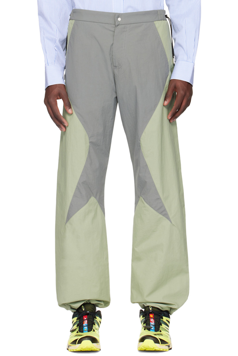 Lightweight nylon taffeta track pants.

· Paneled construction
· Drawstrings at waistband
· Four-pocket styling
· Zip-fly
· Bungee-style drawstring at cuffs

Supplier color: Grey/Green