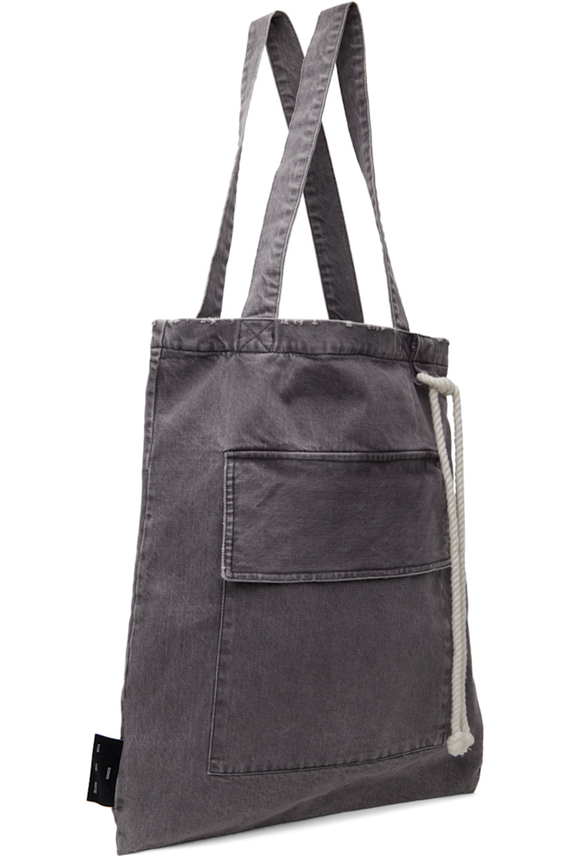 Stonewashed non-stretch denim tote in gray. 

· Distressing and subtle fading throughout
· Twin shoulder straps
· Cord accent at face
· Flap pocket 
· Logo flag at side
· Open throat
· Patch pocket at interior
· Full flannel lining 
· Contrast stitching in black
· H20.5" x W16.75" 

Supplier color: Dark grey