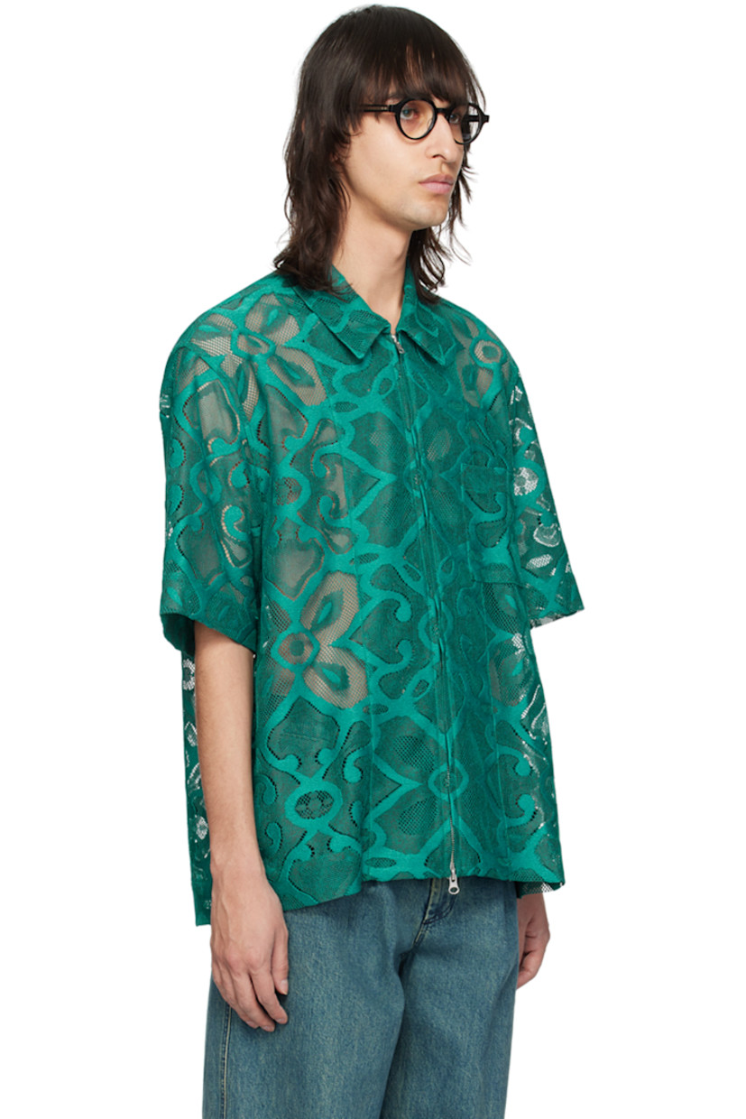 Semi-sheer polyester lace shirt. Graphic pattern embroidered throughout.

· Spread collar
· Two-way zip closure
· Patch pocket at chest
· Vented side seams
· Dropped shoulders

Supplier color: Peacock