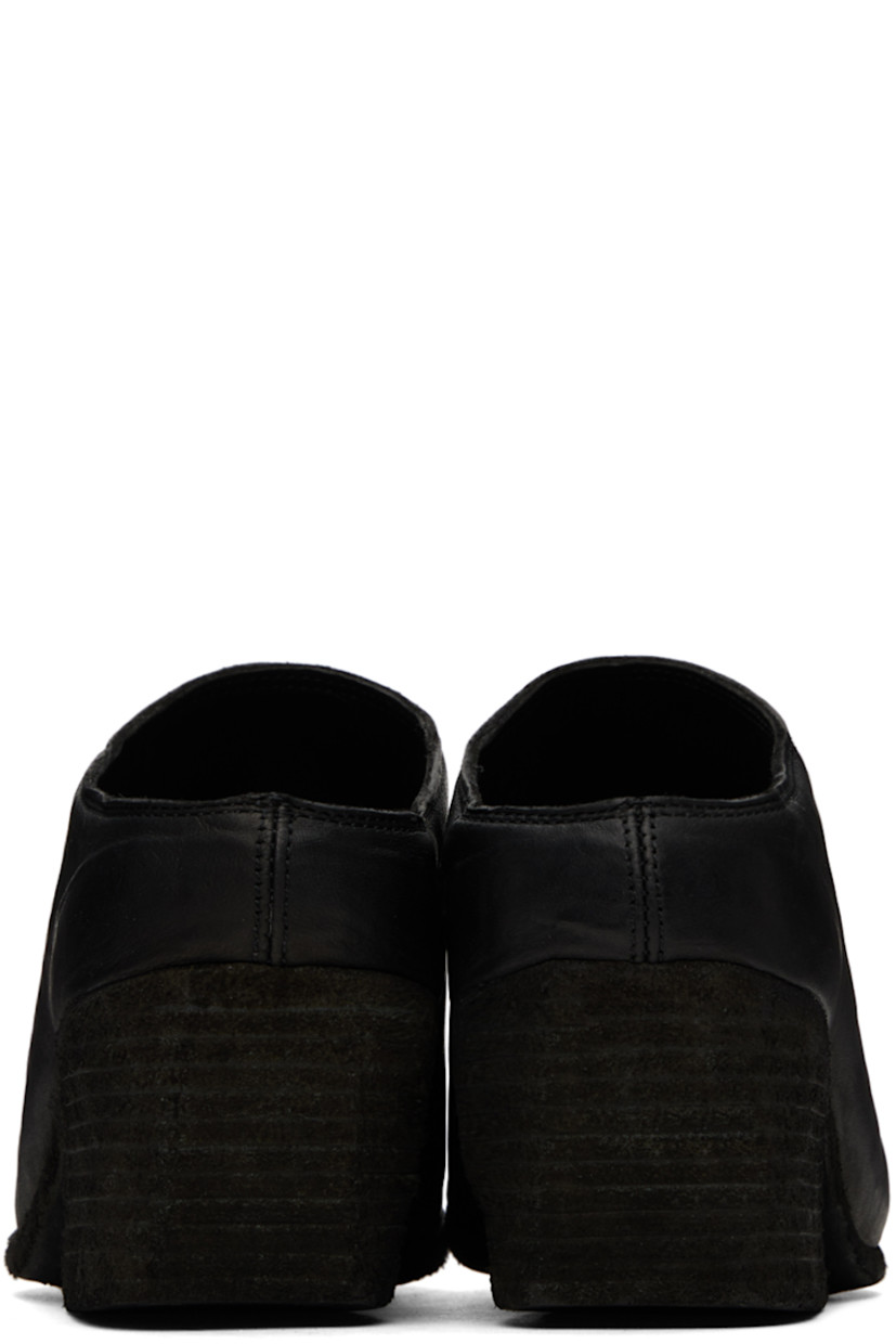 Handcrafted grained horse leather mules in black.

· Pointed toe
· Logo embossed at padded leather footbed
· Stacked leather heel 
· Leather sole
· Heel: H2.25"

Supplier color: Black