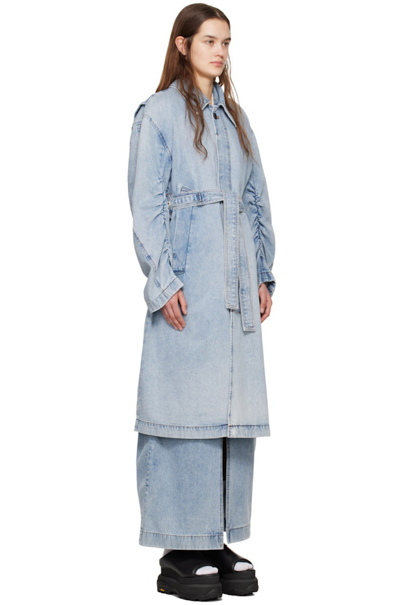 Non-stretch denim coat. Fading throughout.

· Spread collar
· Concealed button closure
· Welt pockets
· Belt loops and detachable self-tie belt at waist
· Dropped shoulders
· Ruching at sleeves
· Logo hardware at back collar
· Storm flap at back
· Contrast stitching in brown

Supplier color: Blue