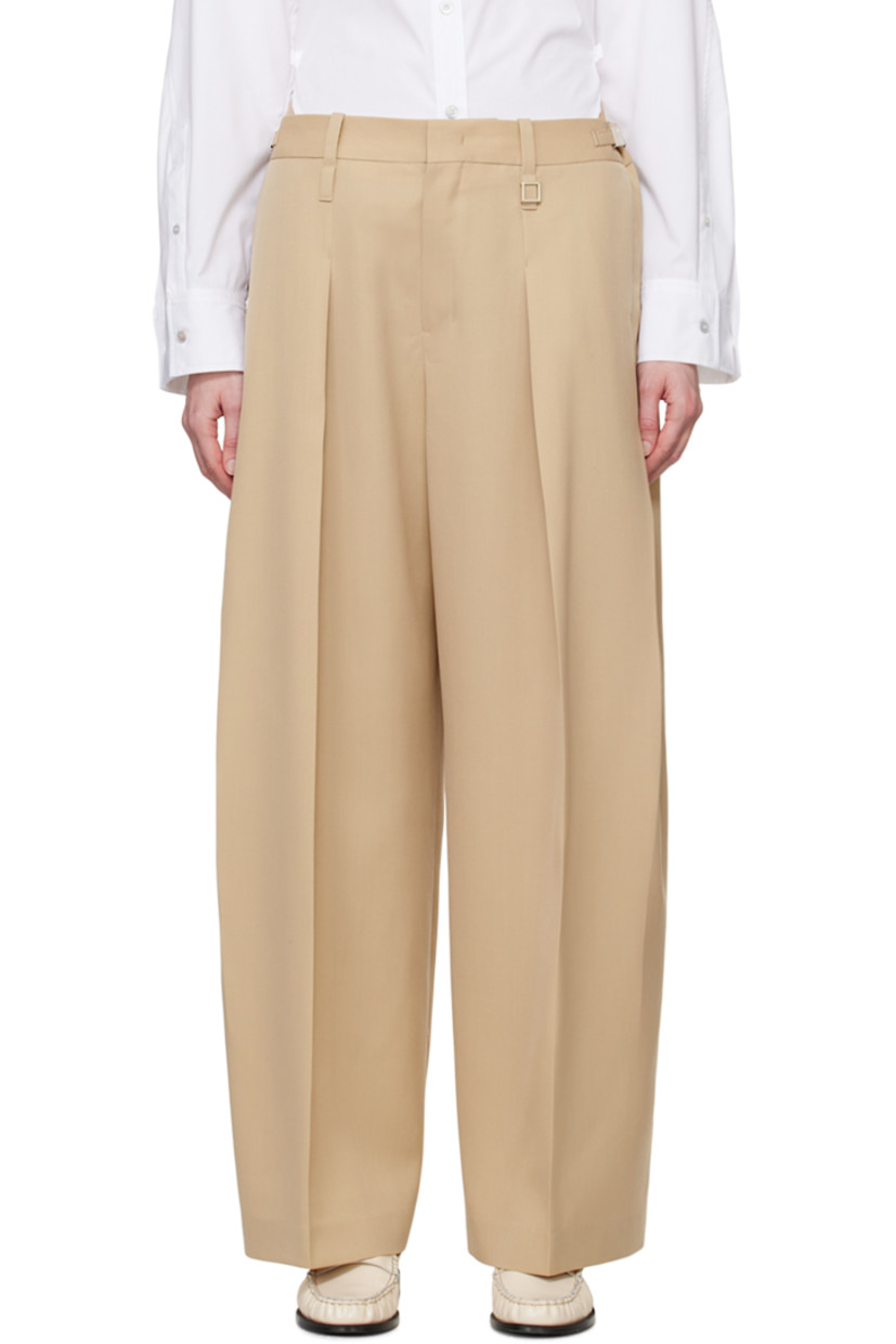 Wool delaine trousers. 

· Belt loops
· Logo hardware and cinch tabs at waistband
· Four-pocket styling
· Zip-fly
· Pleats at front

Supplier color: Beige
