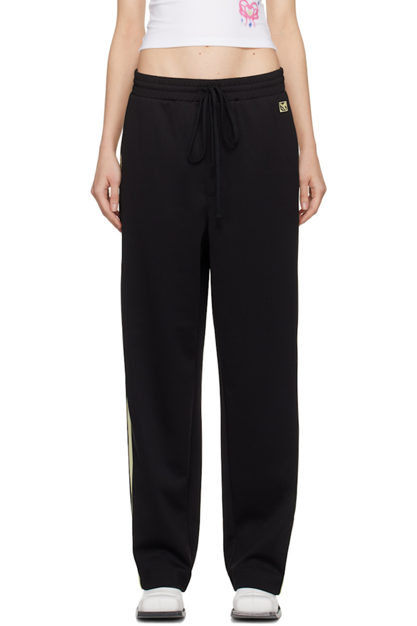 Stretch polyester jersey track pants.

· Drawstring at elasticized waistband
· Four-pocket styling
· Mock-fly
· Logo graphic and logo embroidered at front
· Striped trim at outseams

Supplier color: Black