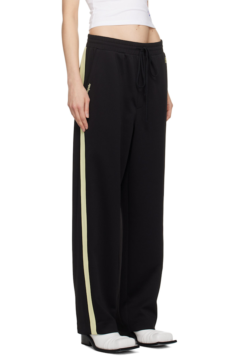 Stretch polyester jersey track pants.

· Drawstring at elasticized waistband
· Four-pocket styling
· Mock-fly
· Logo graphic and logo embroidered at front
· Striped trim at outseams

Supplier color: Black