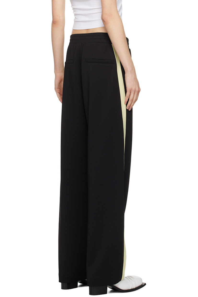 Stretch polyester jersey track pants.

· Drawstring at elasticized waistband
· Four-pocket styling
· Mock-fly
· Logo graphic and logo embroidered at front
· Striped trim at outseams

Supplier color: Black