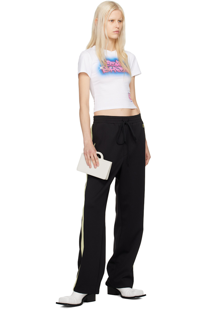 Stretch polyester jersey track pants.

· Drawstring at elasticized waistband
· Four-pocket styling
· Mock-fly
· Logo graphic and logo embroidered at front
· Striped trim at outseams

Supplier color: Black