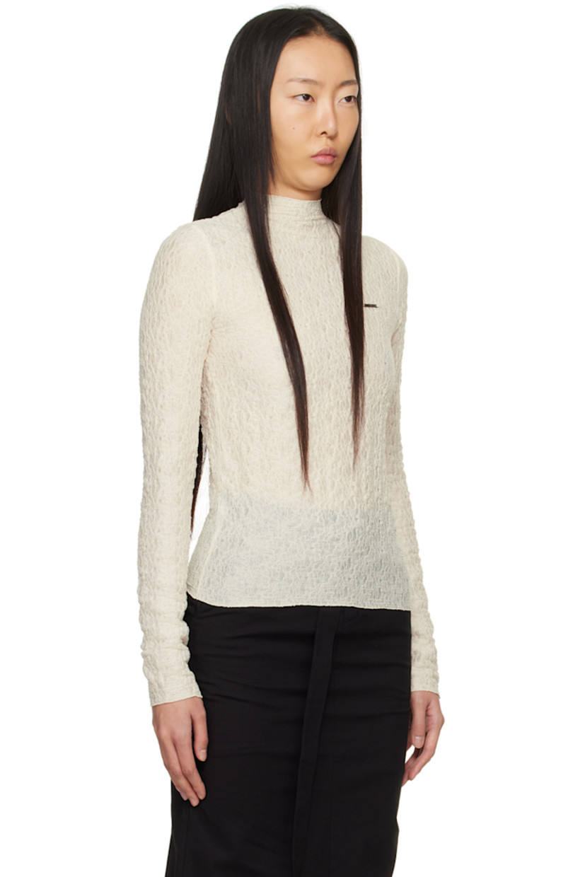 Semi-sheer stretch polyester T-shirt. Shirring throughout. 

· Mock neck 
· Logo plaque at chest 
· Lettuce edge hem and cuffs 
· Button closure at back 

Supplier color: Ivory