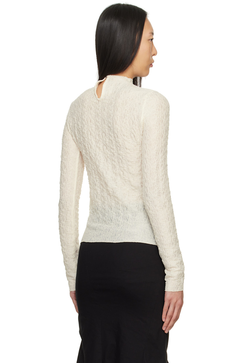 Semi-sheer stretch polyester T-shirt. Shirring throughout. 

· Mock neck 
· Logo plaque at chest 
· Lettuce edge hem and cuffs 
· Button closure at back 

Supplier color: Ivory