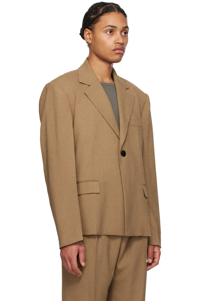 Stretch polyester twill blazer.

· Notched lapel
· Single-button closure
· Welt pocket and flap pockets
· Padded shoulders
· Creased sleeves
· Locker loop at back collar
· Central vent at back hem
· Full satin lining

Supplier color: Camel