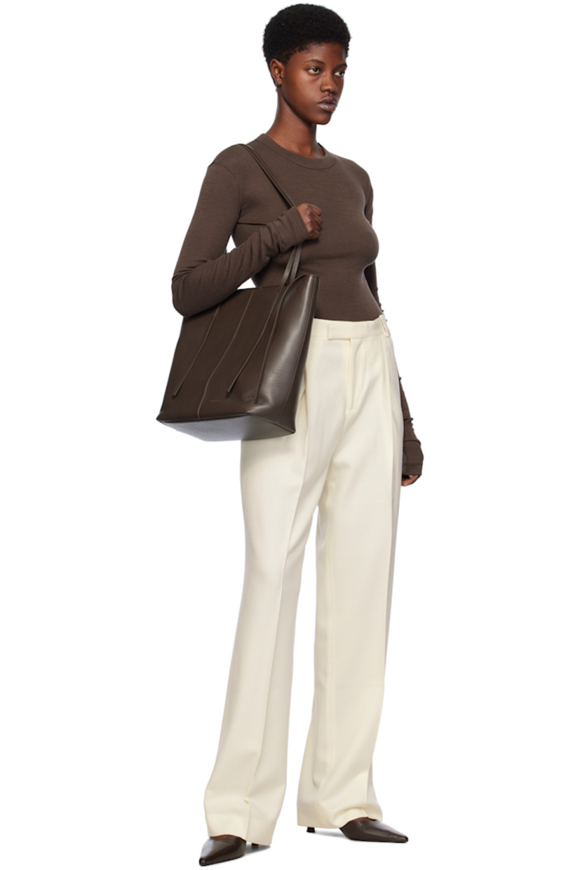 Straight-leg wool flannel trousers.

· Belt loops 
· Four-pocket styling 
· Zip-fly 
· Pleats at front
· Creased legs

Supplier color: Off white