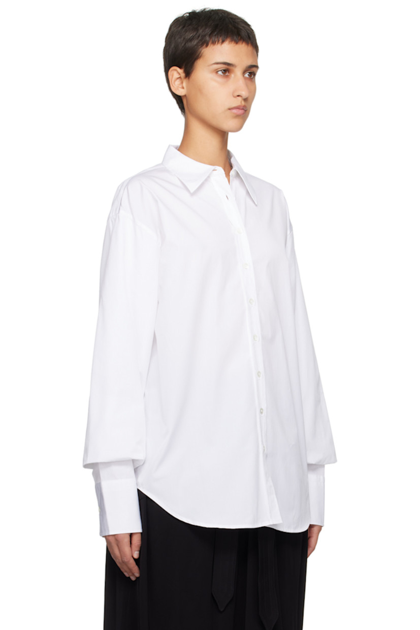 Cotton poplin shirt.

· Pointed collar
· Button closure
· Shirttail hem
· Gathering at bishop sleeves
· Single-button barrel cuffs

Supplier color: White