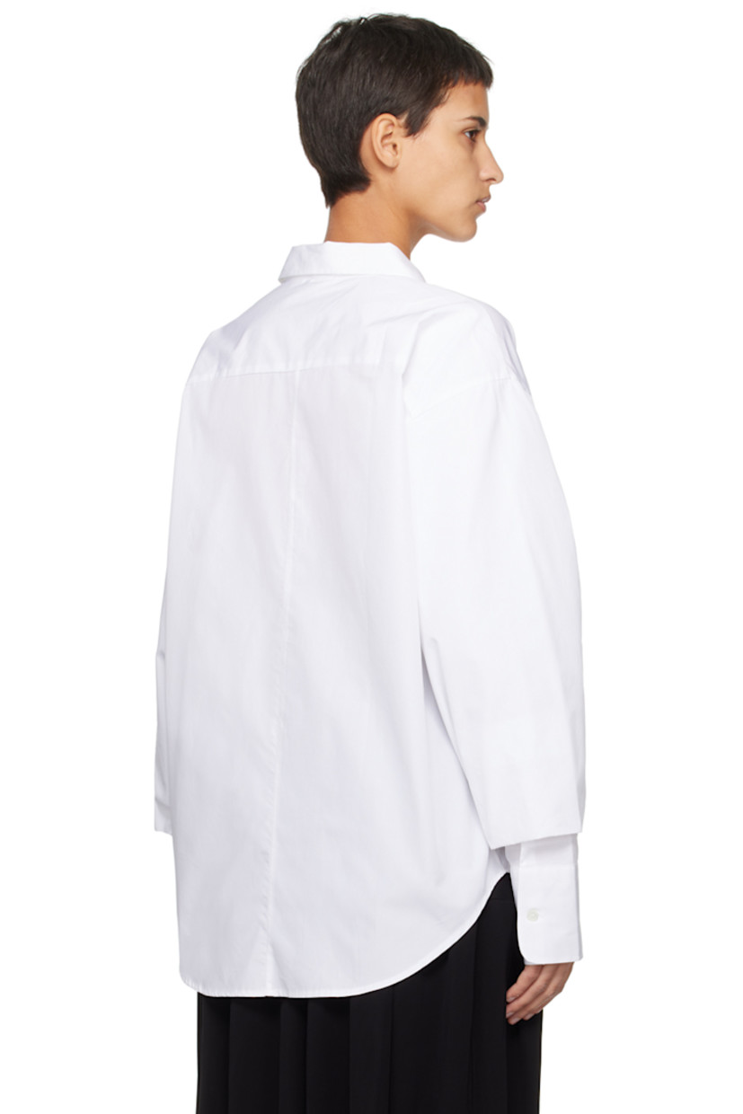 Cotton poplin shirt.

· Pointed collar
· Button closure
· Shirttail hem
· Gathering at bishop sleeves
· Single-button barrel cuffs

Supplier color: White