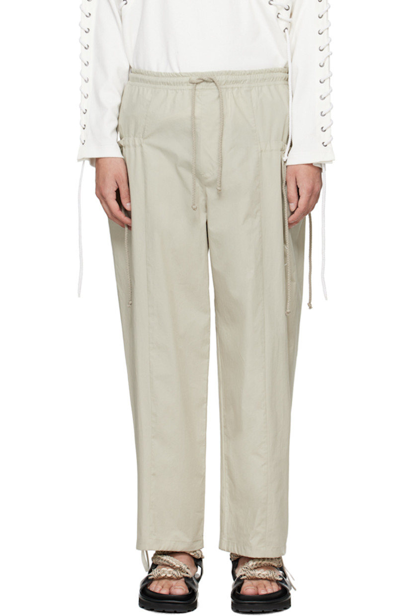 Cotton poplin trousers.

· Drawstring at elasticized waistband 
· Two-pocket styling
· Drawstring at pockets and cuffs
· Logo embroidered at front 

Supplier color: Beige