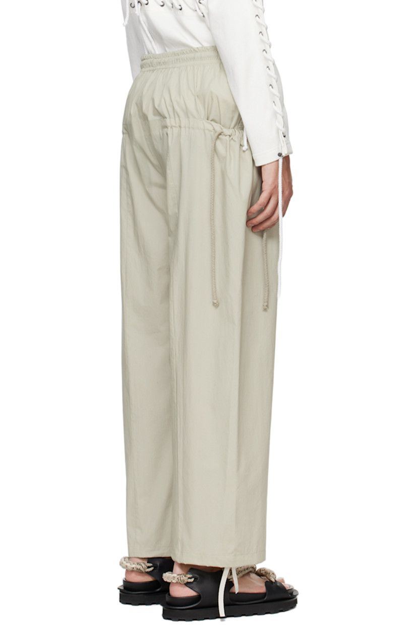 Cotton poplin trousers.

· Drawstring at elasticized waistband 
· Two-pocket styling
· Drawstring at pockets and cuffs
· Logo embroidered at front 

Supplier color: Beige