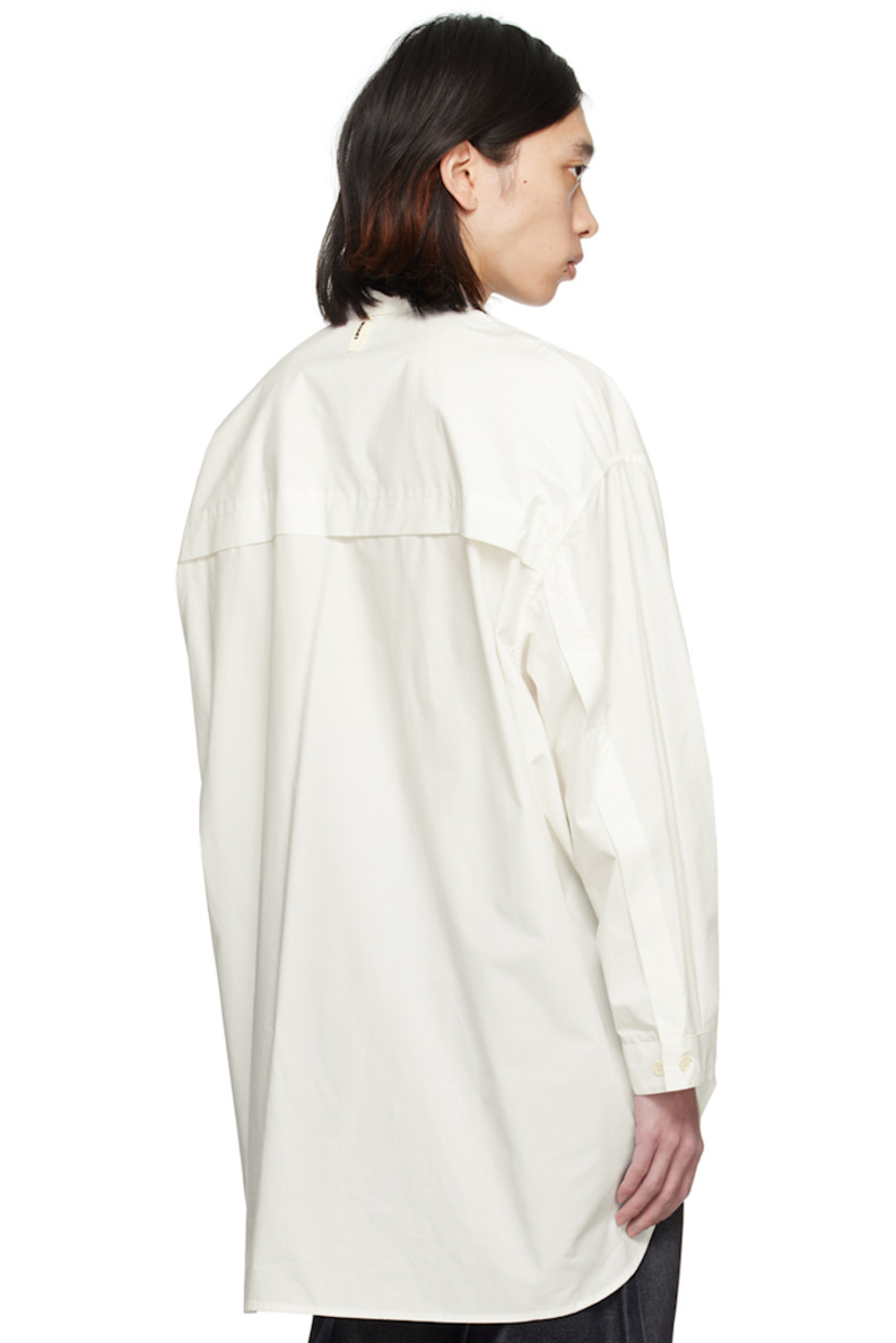 Cotton poplin shirt. 

· Spread collar
· Concealed button closure
· Shirttail hem
· Dropped shoulders
· Pleat at adjustable single-button barrel cuffs

Supplier color: Off-white
