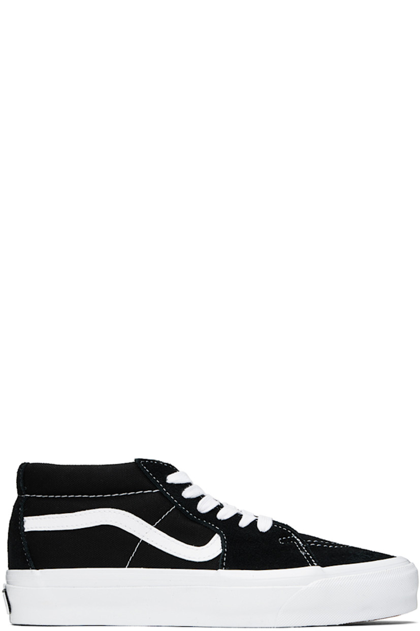 Mid-top 8 oz canvas and suede sneakers in black and white.

· Perforated detailing at rubber cap toe
· Lace-up closure
· Logo patch at padded tongue
· Padded collar
· Grained leather Sidestripe™ at sides
· Padded Sola ADC foam insole
· Grained leather lining
· Rubberized logo patch at heel midsole
· Treaded rubber sole

Supplier color: Black/White