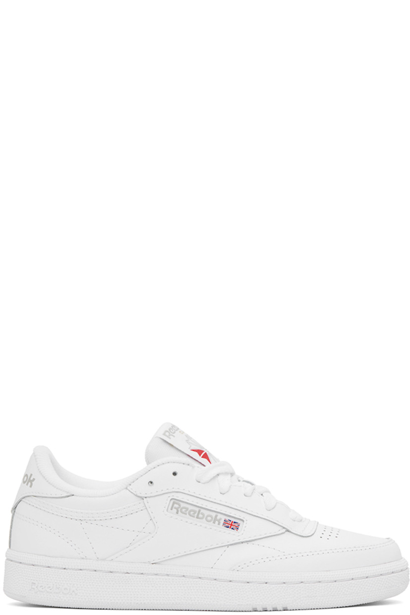 Low-top buffed leather sneakers in white.

· Perforated detailing at toe
· Lace-up closure
· Logo patch at padded tongue
· Padded collar
· Inset logo patch at outer side
· Logo printed at heel counter
· Terrycloth lining
· Treaded rubber sole

Supplier color: White/Light grey