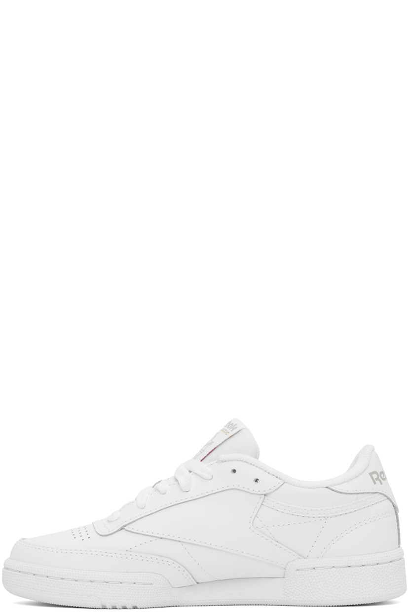 Low-top buffed leather sneakers in white.

· Perforated detailing at toe
· Lace-up closure
· Logo patch at padded tongue
· Padded collar
· Inset logo patch at outer side
· Logo printed at heel counter
· Terrycloth lining
· Treaded rubber sole

Supplier color: White/Light grey