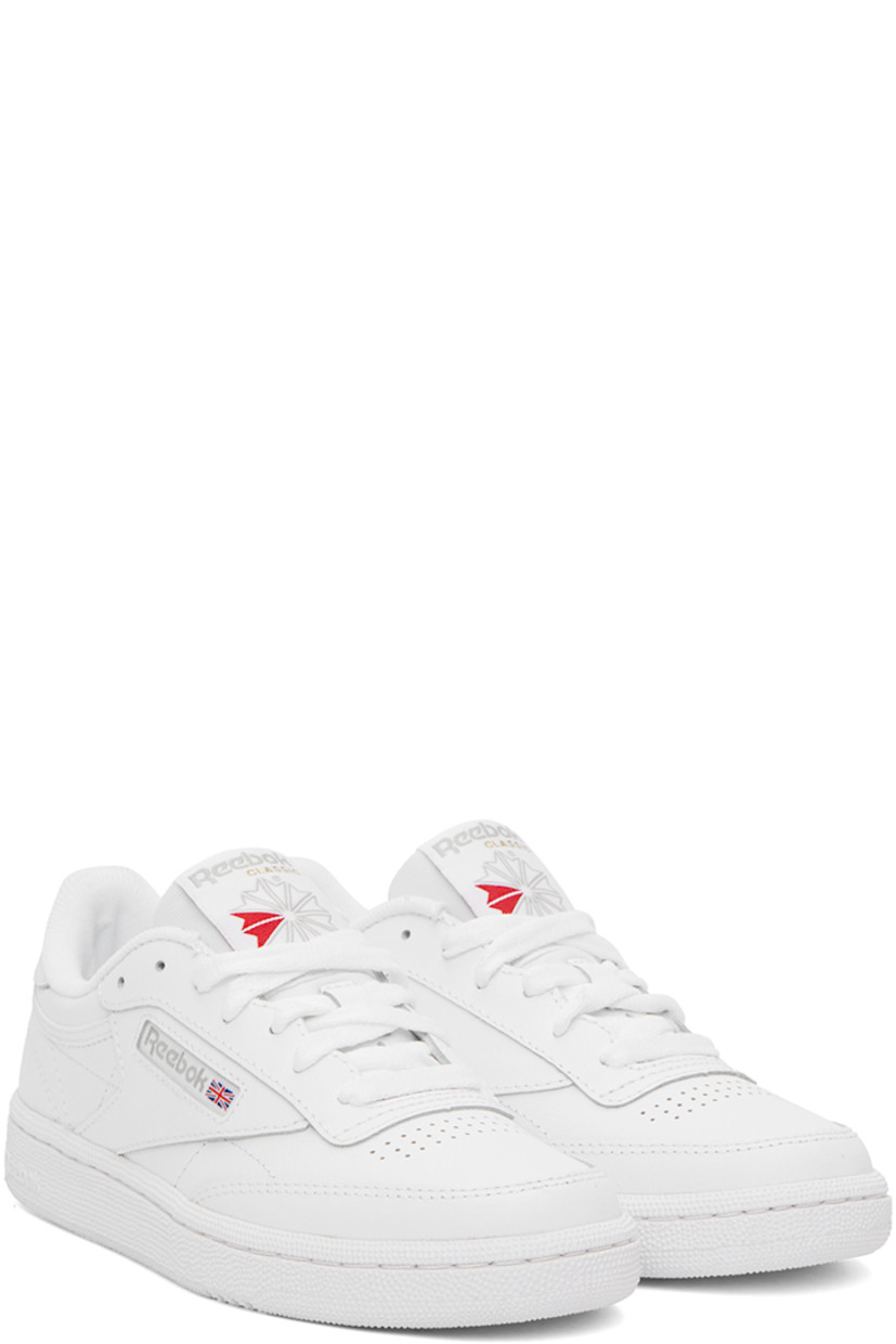 Low-top buffed leather sneakers in white.

· Perforated detailing at toe
· Lace-up closure
· Logo patch at padded tongue
· Padded collar
· Inset logo patch at outer side
· Logo printed at heel counter
· Terrycloth lining
· Treaded rubber sole

Supplier color: White/Light grey