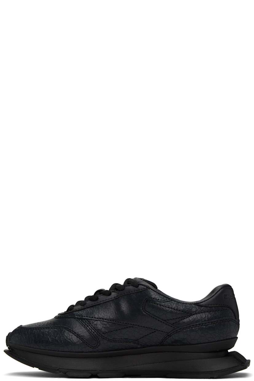 Low-top cracked leather sneakers in black. 

· Perforated detailing at toe and sides
· Lace-up closure
· Logo embossed at padded tongue
· Padded collar
· Logo flag at outer side
· Logo embossed at heel counter
· Grained leather and canvas lining
· Sculptural foam rubber midsole
· Treaded rubber outsole

Supplier color: Cracked black