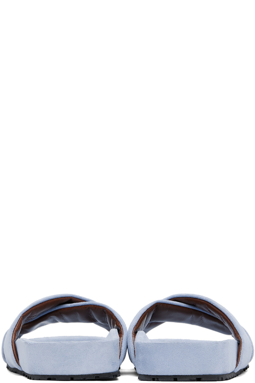 Calfskin suede slip-on flat sandals in blue.

· Open toe
· Logo-embossed padded criss-crossing straps
· Logo stamp at calfskin suede molded footbed
· Treaded rubber sole

Supplier color: Light blue