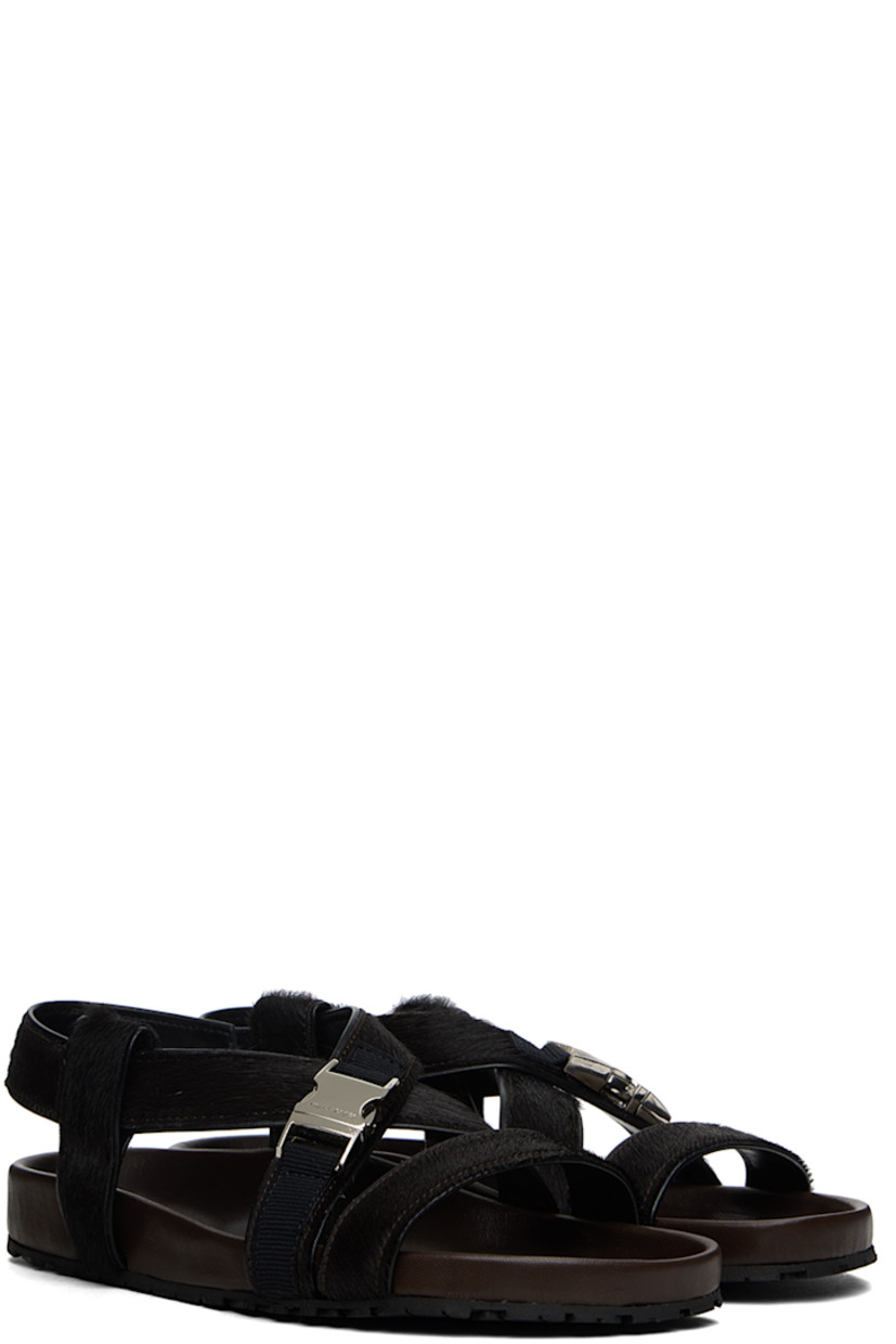 Calf-hair flat sandals in brown.

· Open toe
· Criss-crossing strap at vamp
· Logo-engraved press-release hardware at vamp
· Partially elasticized slingback strap 
· Logo stamp at molded leather footbed
· Treaded rubber sole

Supplier color: Dark brown