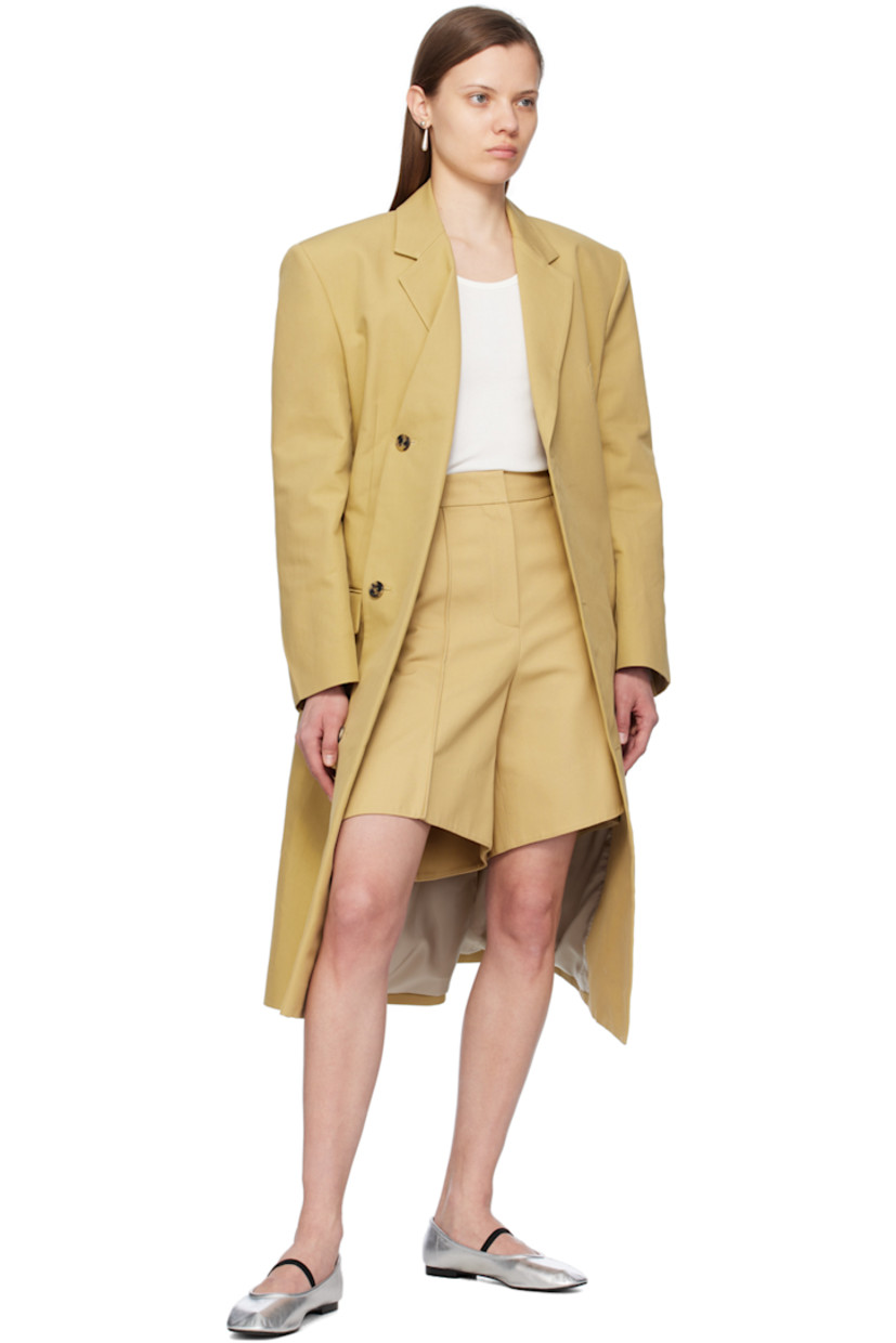 Plain-woven cotton coat.

· Notched lapel
· Folded double-breasted button closure
· Welt pocket and flap pockets
· Padded shoulders
· Vented cuffs
· Central vent at back hem
· Full Bemberg cupro-blend satin lining 

Supplier color: Khaki beige