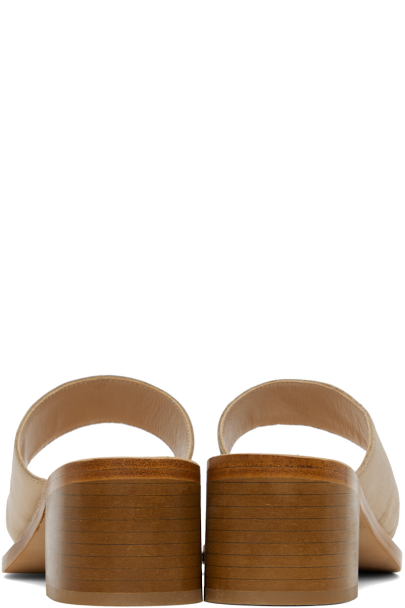 Grained calfskin heeled sandals in beige.

· Thong-style strap at open toe
· Strap at vamp
· Logo embossed at footbed
· Topstitching at welt
· Stacked leather block heel with rubber injection
· Leather sole
· Heel: H2"

Supplier color: Camel calf