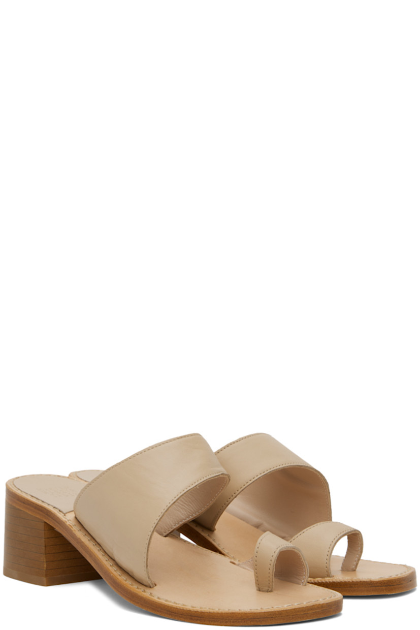 Grained calfskin heeled sandals in beige.

· Thong-style strap at open toe
· Strap at vamp
· Logo embossed at footbed
· Topstitching at welt
· Stacked leather block heel with rubber injection
· Leather sole
· Heel: H2"

Supplier color: Camel calf