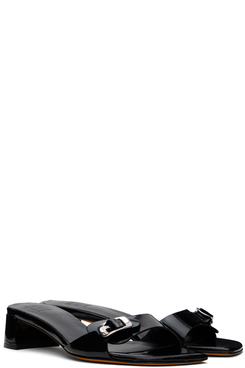 Patent leather heeled sandals in black.

· Open square toe
· Pin-buckle strap at vamp
· Logo embossed at padded leather footbed
· Grained leather lining
· Covered block heel with rubber injection
· Nubuck sole
· Heel: H1.25"

Supplier color: Black