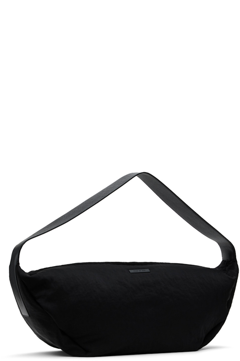 Textured twill shoulder bag in black.

· Fixed grained calfskin shoulder strap
· Leather logo patch at face
· Two-way zip closure
· Zip pocket at interior
· Faux-suede lining
· H10" x W24" x D7.5"

Supplier color: Black