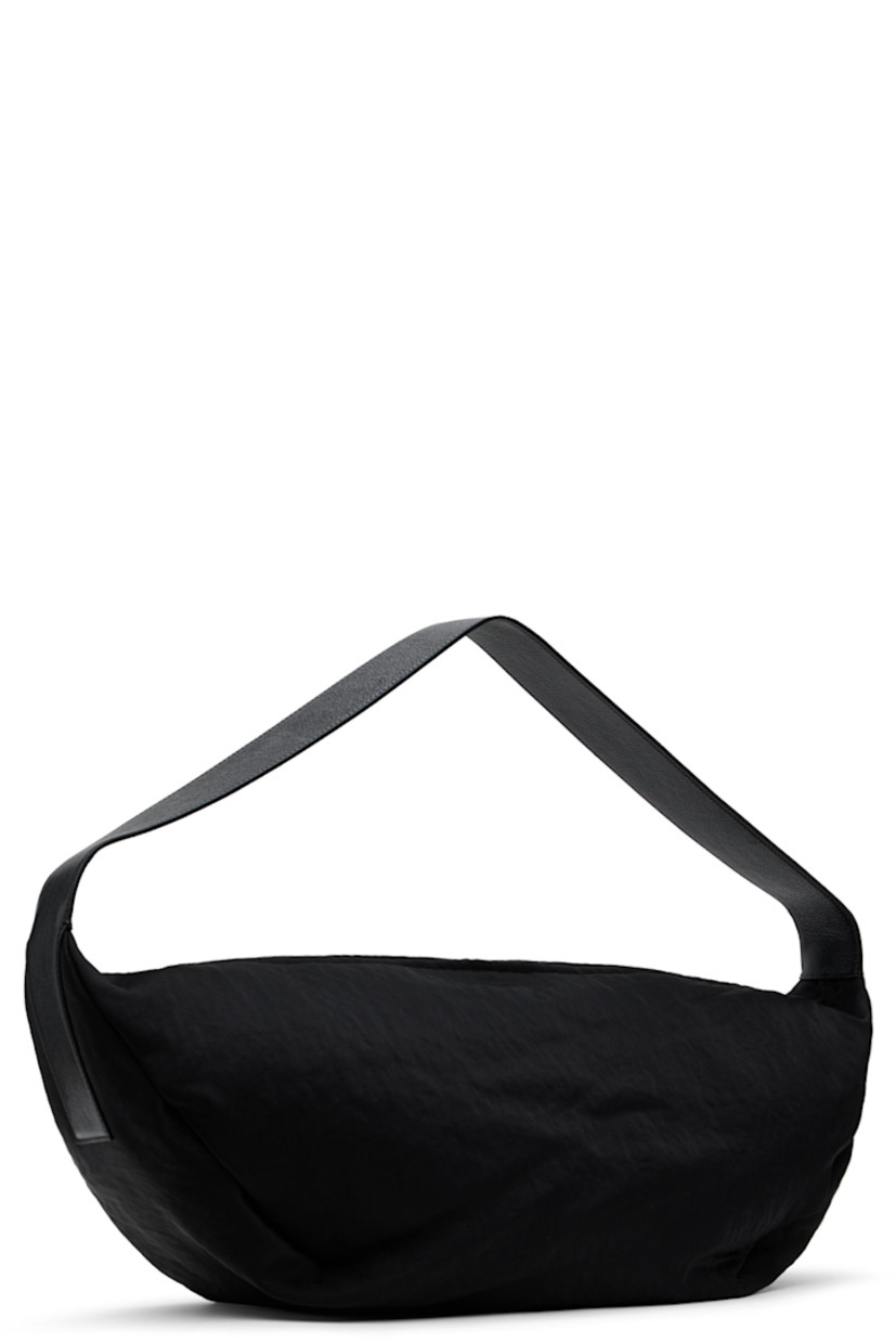 Textured twill shoulder bag in black.

· Fixed grained calfskin shoulder strap
· Leather logo patch at face
· Two-way zip closure
· Zip pocket at interior
· Faux-suede lining
· H10" x W24" x D7.5"

Supplier color: Black