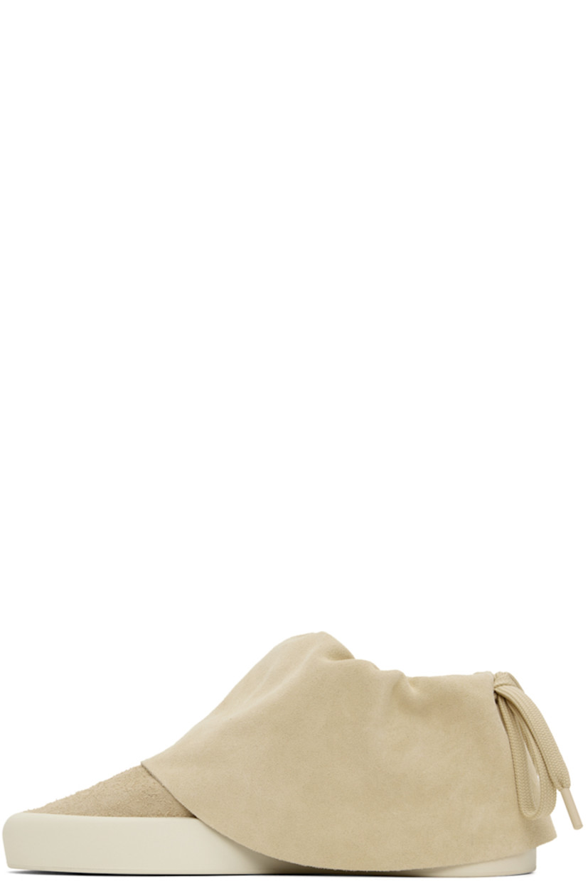 Low-top suede sneakers in beige. 

· Drawstring at padded foldover collar
· Neoprene and mesh lining
· Rubberized logo patch at heel 
· Rubber sole

Supplier color: Sand