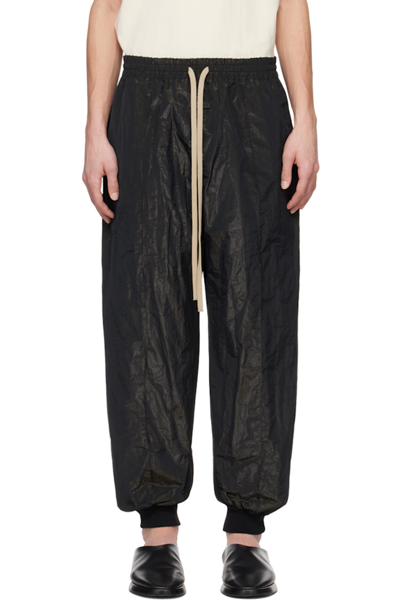 Crinkled polyester lamé taffeta track pants.

· Drawstring at elasticized waistband
· Two-pocket styling
· Leather logo patch at front
· Pintucks at legs  
· Rib knit cuffs

Supplier color: Black