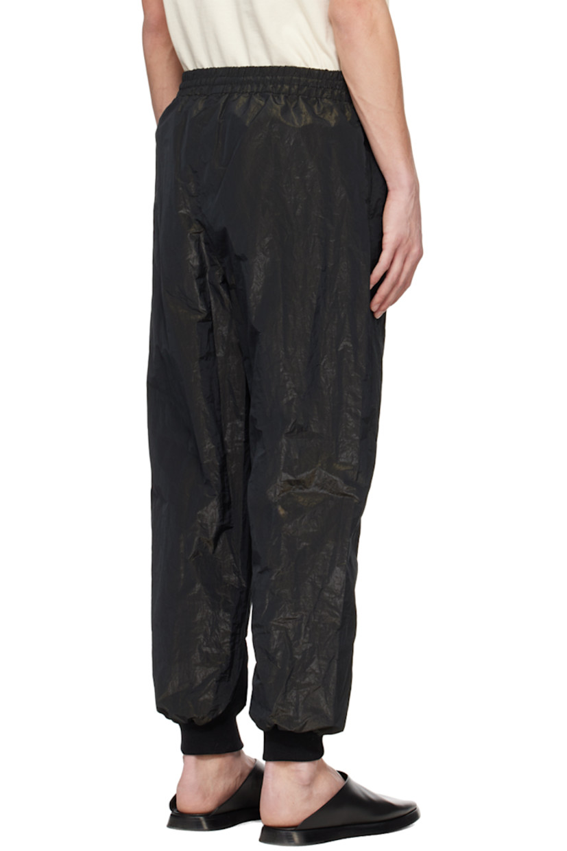 Crinkled polyester lamé taffeta track pants.

· Drawstring at elasticized waistband
· Two-pocket styling
· Leather logo patch at front
· Pintucks at legs  
· Rib knit cuffs

Supplier color: Black