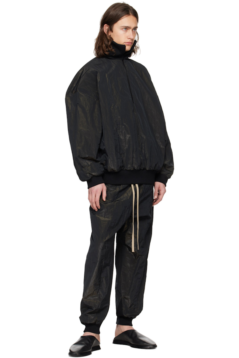 Crinkled polyester lamé taffeta track pants.

· Drawstring at elasticized waistband
· Two-pocket styling
· Leather logo patch at front
· Pintucks at legs  
· Rib knit cuffs

Supplier color: Black
