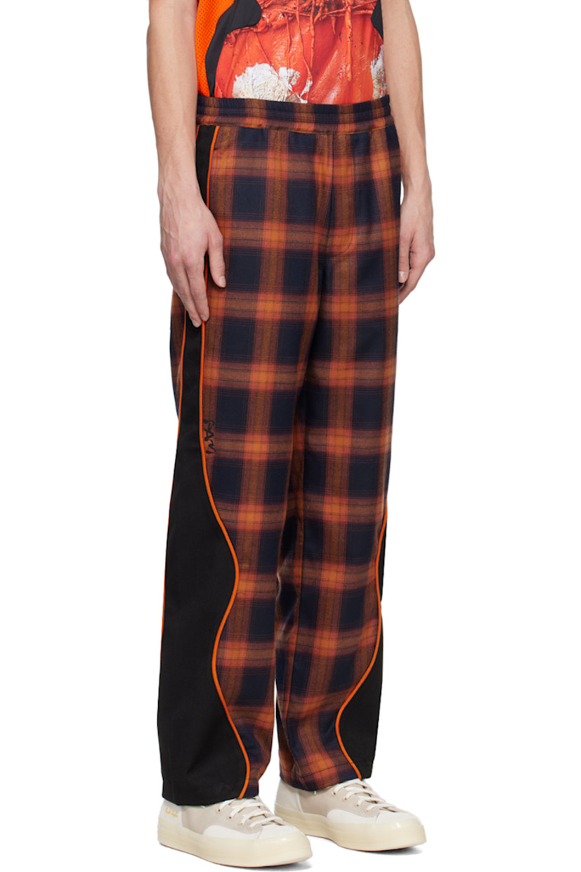 Straight-leg polyester-blend flannel and stretch polyester-blend serge track pants. Jacquard check pattern throughout.

· Paneled construction
· Drawstring at elasticized waistband
· Three-pocket styling
· Logo bonded at leg
· Piping at outseams

Supplier color: Orange plaid