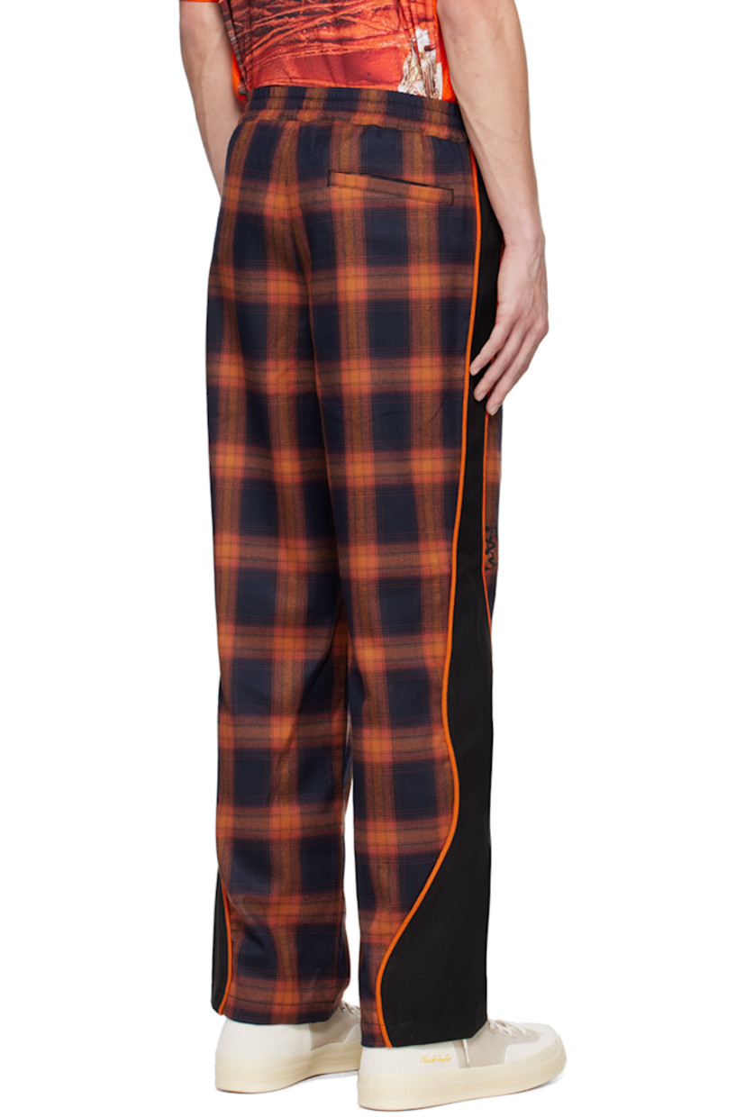 Straight-leg polyester-blend flannel and stretch polyester-blend serge track pants. Jacquard check pattern throughout.

· Paneled construction
· Drawstring at elasticized waistband
· Three-pocket styling
· Logo bonded at leg
· Piping at outseams

Supplier color: Orange plaid