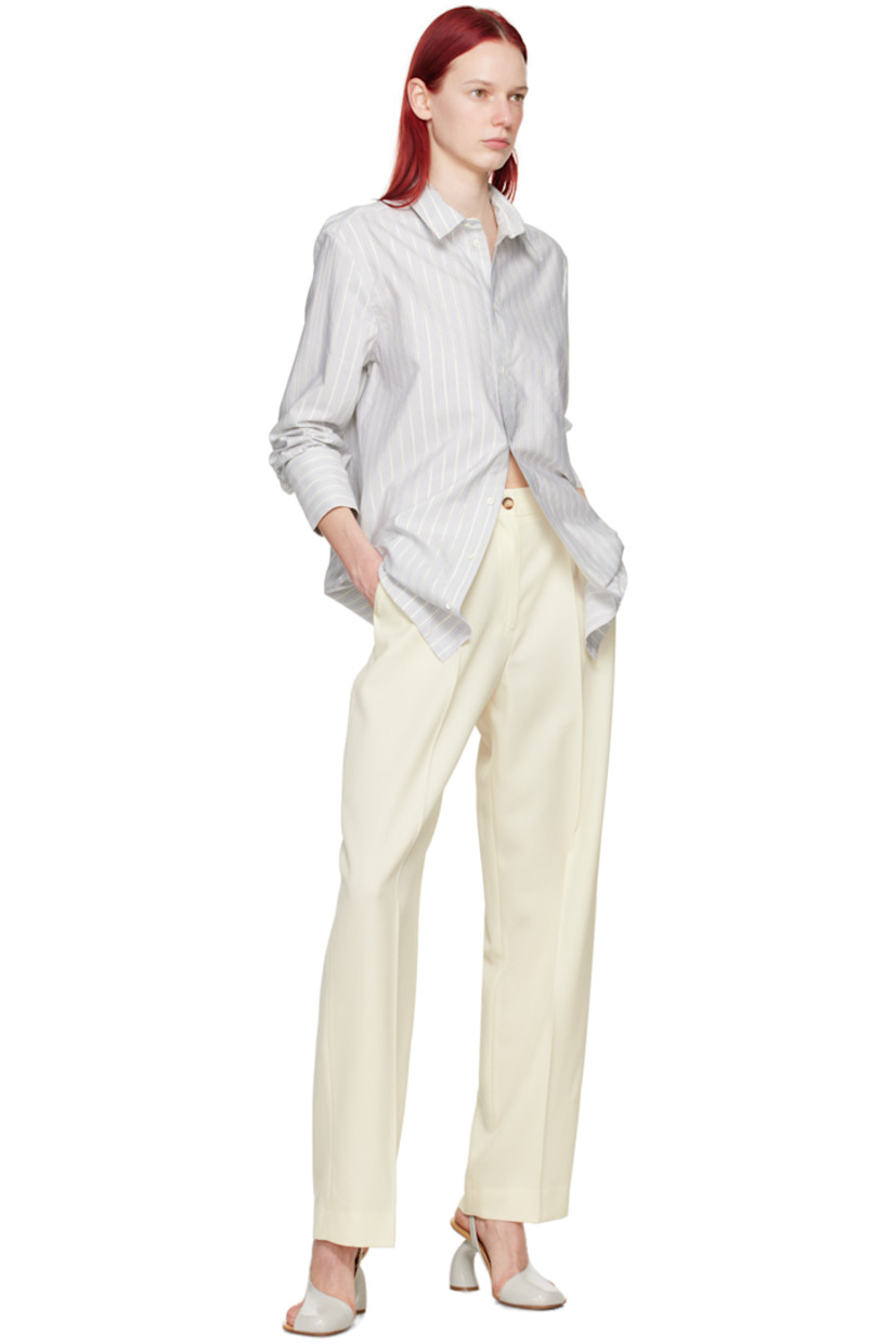 Loose-fit stretch virgin wool serge trousers.

· High-rise
· Belt loops
· Four-pocket styling
· Zip-fly
· Pleats at front
· Creased legs

Supplier color: Off-white