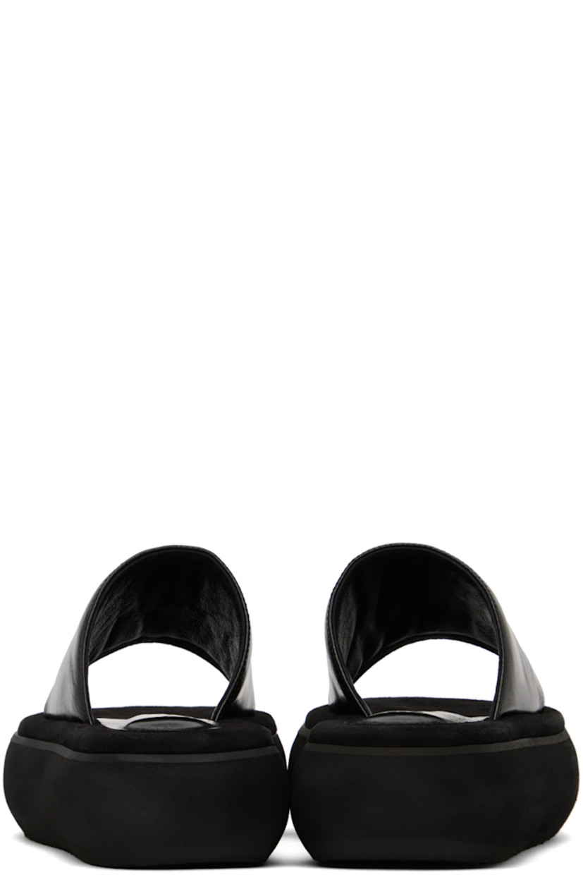 Crinkled leather slides in black.

· Open square toe
· Logo-embossed padded leather and suede footbed
· Grained leather lining
· Platform EVA foam rubber midsole
· Treaded rubber sole
· Platform: H2"

Supplier color: Washed black