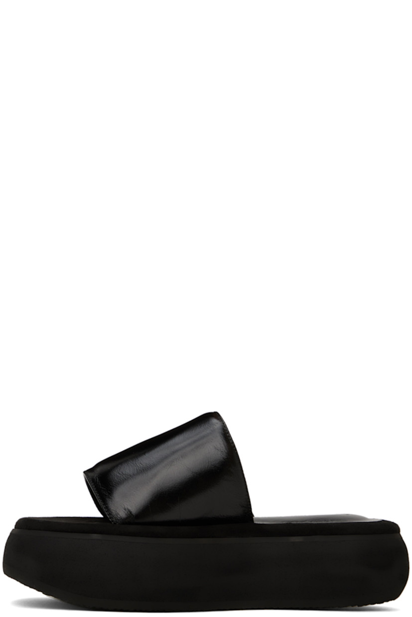 Crinkled leather slides in black.

· Open square toe
· Logo-embossed padded leather and suede footbed
· Grained leather lining
· Platform EVA foam rubber midsole
· Treaded rubber sole
· Platform: H2"

Supplier color: Washed black