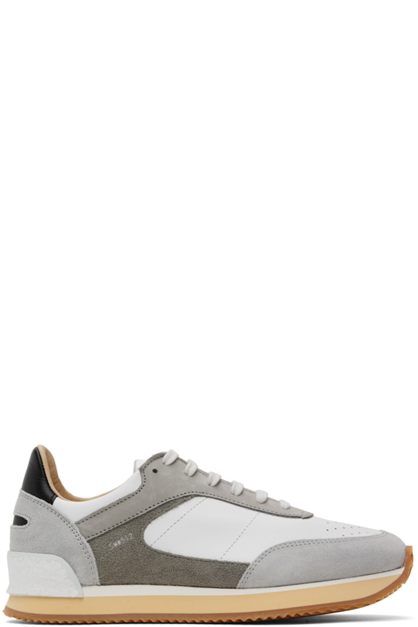 Low-top paneled grained leather, suede, and buffed leather sneakers in white and tones of gray.

· Perforated detailing at toe
· Lace-up closure
· Logo patch at tongue 
· Padded collar
· Buffed leather and suede lining
· Stacked foam rubber midsole
· Treaded rubber sole

Supplier color: Grey