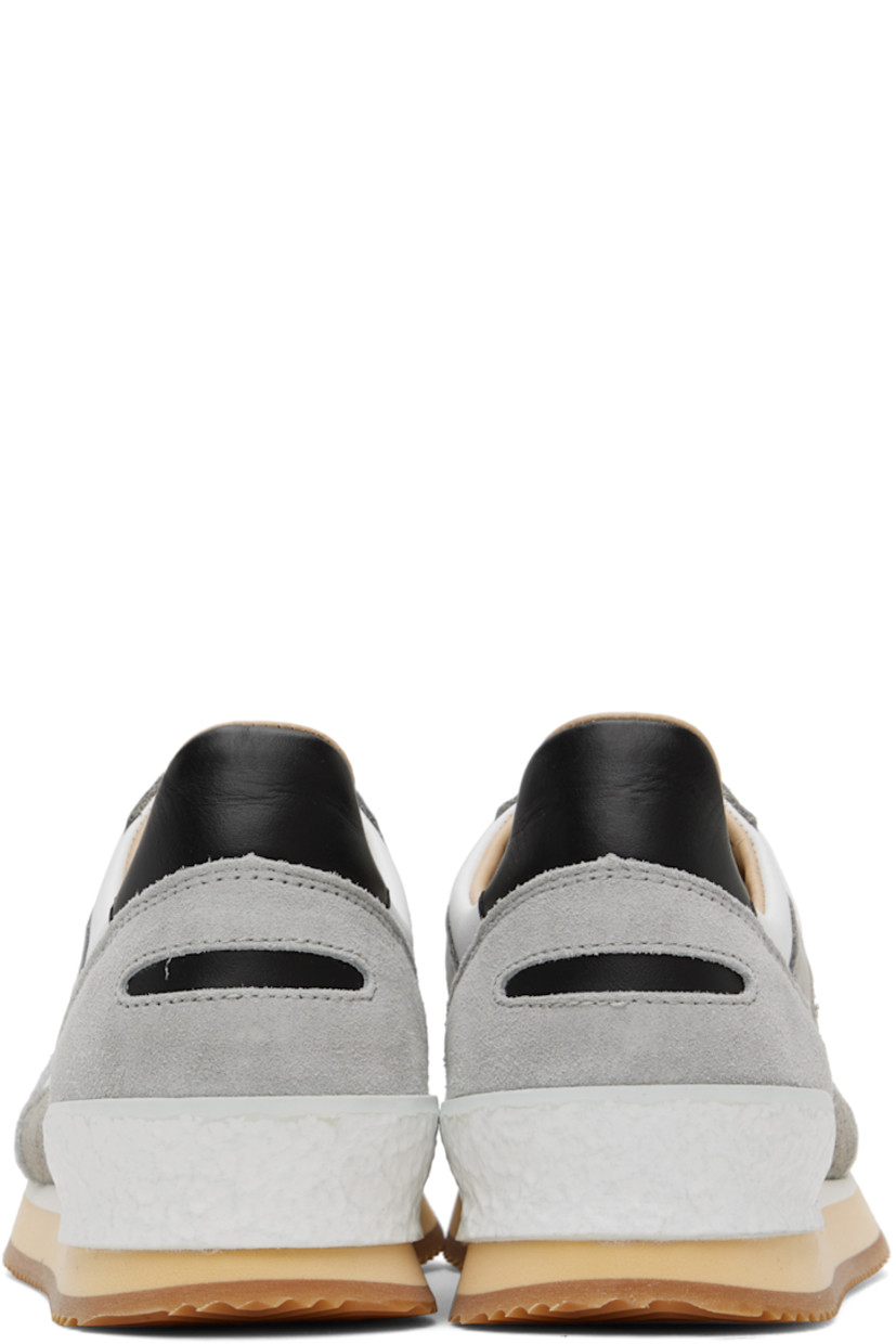Low-top paneled grained leather, suede, and buffed leather sneakers in white and tones of gray.

· Perforated detailing at toe
· Lace-up closure
· Logo patch at tongue 
· Padded collar
· Buffed leather and suede lining
· Stacked foam rubber midsole
· Treaded rubber sole

Supplier color: Grey